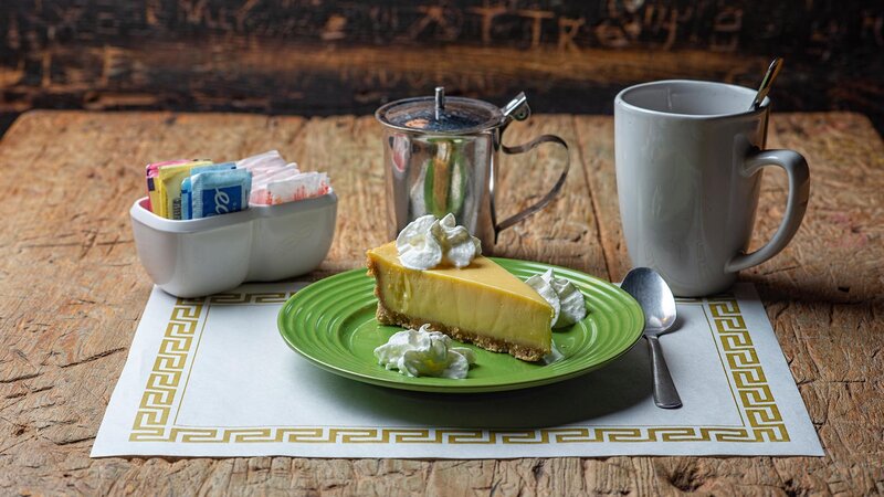 Key lime pie dessert with cup of coffee